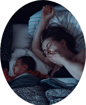 Mom breastfeeding in bed and baby all tucked in ready to sleep